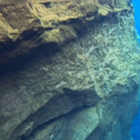 The clear blue water between the rock walls of Silfra
