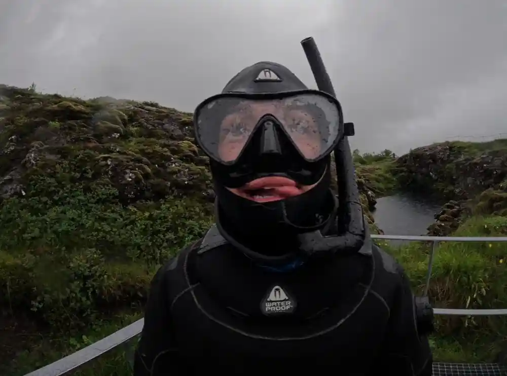 Diver head portrait with snorkel on overcast shore