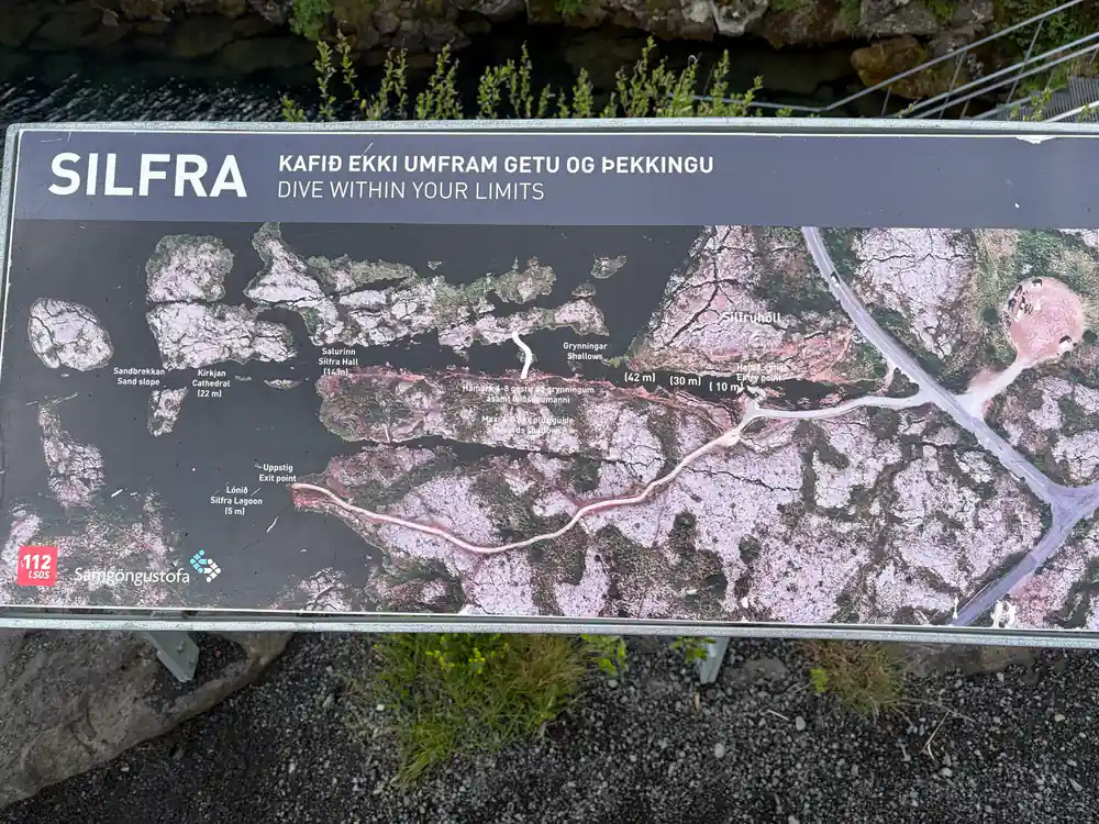 Informational sign about diving site with aerial map view